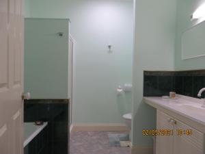 a bathroom with a shower and a sink and a toilet at Arabella Country House in Princetown