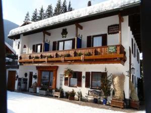 a large white building with a balcony on it at Gästehaus Schwaiger in Schönau am Königssee