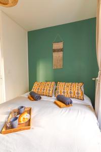 a bedroom with a bed with a tray of food on it at Le Chanzy-Terrasse privative in Saumur