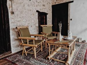a room with two chairs and a wooden table at National monument Mehmedbasica Kuca in Stolac