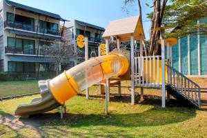 a playground with a slide and a play structure at Bangsaen Heritage Hotel - SHA Plus Certified in Bangsaen