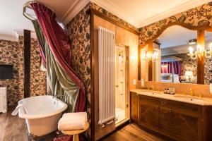 a bathroom with a tub and a sink at Château Gütsch in Luzern