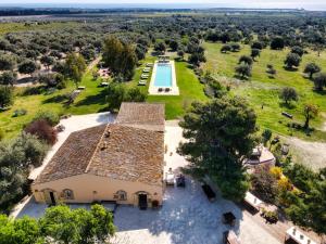 an aerial view of a house with a swimming pool at Terre Di Vendicari in Noto