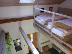 an attic room with two bunk beds and a staircase at Merum Pincészet és Vendégszoba in Tállya