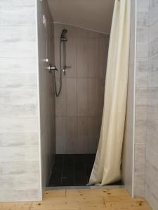 a bathroom with a shower with a shower curtain at In campagna in La Spezia