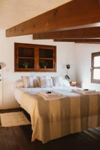 a bedroom with a large bed with a window at Casa Rural Sansaba in Seville +79 photos