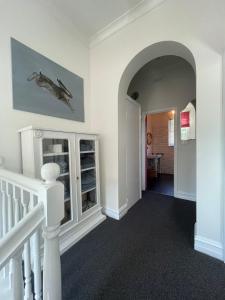 a hallway with a staircase with a white stair case at Webster Terrace in Ballarat