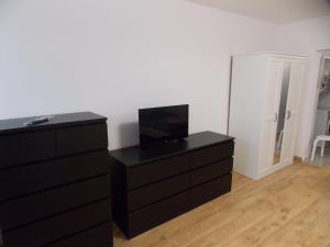 a living room with a dresser and a black cabinet at Garsoniera moderna in Bucharest