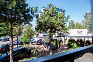 a view from a balcony of a parking lot with cars at Jijo's Hotel in Mamaia