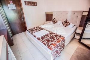 Postel nebo postele na pokoji v ubytování Jijo's Hotel