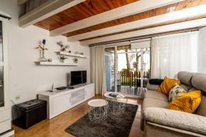 a living room with a couch and a tv at Solymar in Denia