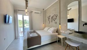 a bedroom with a bed and a sink and a bathroom at Ninfas del Mar in Agios Nikitas