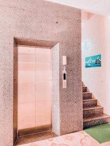 a door in a building with stairs in front at Thien Nhan Hotel in Cửa Lô