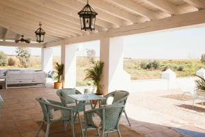 an outdoor patio with a table and chairs at Casa Rural Sansaba in Seville