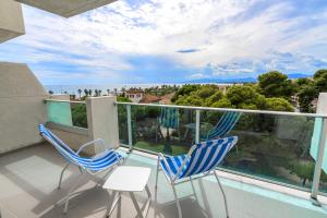 a balcony with two chairs and a view at Blaumar Hotel in Salou