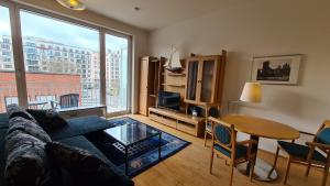 a living room with a couch and a table at TopDomizil Apartments Berlin Mitte in Berlin