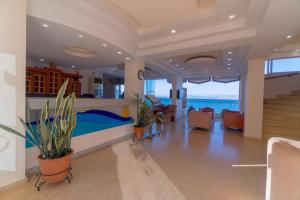 a large living room with a swimming pool in a house at Corfu Maris in Benitses