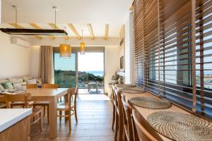 a dining room with a long table and chairs at Villa Theano in Triopetra