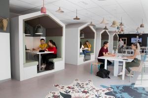 a group of people sitting at tables in a room at Résidence Kley in Marseille