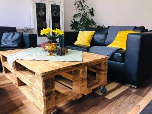 a living room with a couch and a wooden coffee table at Mała Czantoria in Ustroń