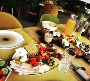 a table with a plate of food on a table at AQUARIUS BOUTIQUE HOTEL in Câmpulung Moldovenesc