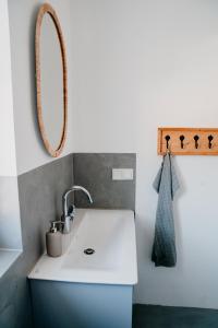 a bathroom with a sink and a mirror at WohnWerk Ferienwohnungen Lautenthal in Langelsheim
