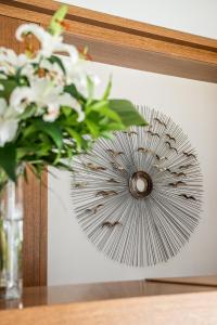 a vase with white flowers sitting on a table at Stellina Village in Kato Daratso