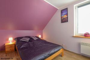 A bed or beds in a room at Apartamenty Rybacka 84B m34