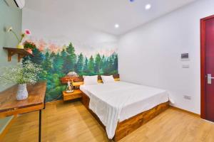 a bedroom with a bed with a painting on the wall at Lakeside House in Hanoi