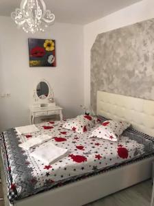 シビウにあるUnser Hausのベッドルーム1室(赤い花のベッド1台付)