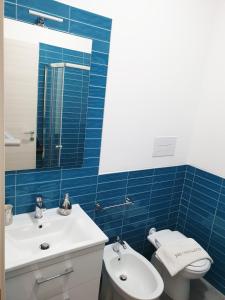 a bathroom with a sink and a toilet and a mirror at B&B Castelluccio in Villafranca Tirrena +31 photos