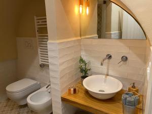 a bathroom with a sink and a toilet at Via Roma 181 in Polignano a Mare