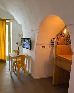 a kitchen and dining room with a table and a dining room at Via Roma 181 in Polignano a Mare