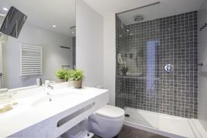 ein Bad mit einem Waschbecken, einem WC und einer Dusche in der Unterkunft Blaumar Hotel in Salou
