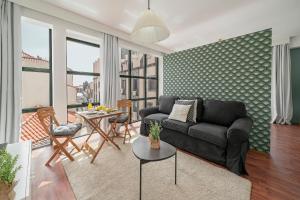 a living room with a couch and a table at Pelourinho Apartments by An Island Apart in Funchal