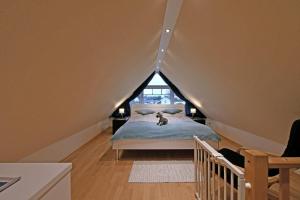 a bedroom with a bed with a cat sitting on it at Appartement-Blume-PCH-16B in Scharbeutz