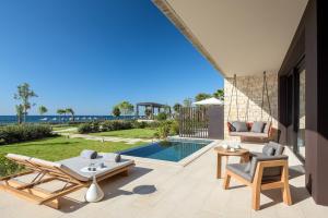 a patio with a view of a swimming pool at Amara - Sea Your Only View™ in Limassol