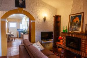 a living room with a couch and a fireplace at Quinta Forum in Tocha
