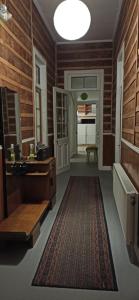 a bathroom with wooden walls and a large rug at Casa Bike in Punta Arenas