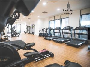 a gym with rows of treadmills in a room at 1 bedroom lovely apartment in Salford quays free street parking subject to availability in Manchester