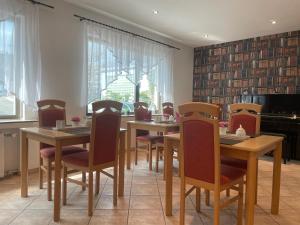 a dining room with wooden tables and chairs at Haus Sonnenschein in Monheim