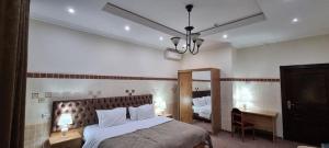 Säng eller sängar i ett rum på Salam Inn