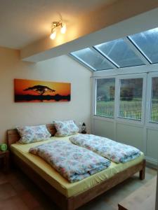 a bedroom with two beds in a room with a window at Weinhaus Paradies in Neustadt an der Weinstraße