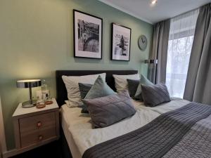 a bedroom with a bed with pillows and a window at RhePi-Apartment in Essen