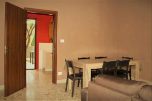 a dining room with a table and chairs and a couch at MAKANI APARTMENTS - San Vito Lo Capo in San Vito lo Capo