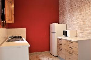 Η κουζίνα ή μικρή κουζίνα στο MAKANI APARTMENTS - San Vito Lo Capo +21 φωτογραφίες