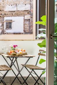 a table with food on it next to a window at Cassaro261 B&B in Palermo