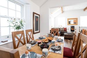 a living room with a table with food on it at Finest Retreats - Lighthouse Cottage in Rampside