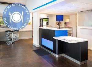 a kitchen with a blue and white counter in a room at Hôtel Ibis Budget Nantes Ouest Atlantis Couëron in Couëron