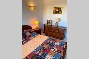 a bedroom with two beds and a dresser at Cocooning in Torreilles